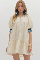 Sporty chic cream half-zip dress with puff sleeves and contrast striped collar