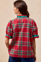 Back View Woman wearing red plaid blouse with green trim and ruffled puff sleeves – festive holiday top by Petunias of Naples