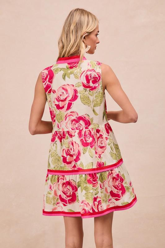 Woman wearing a floral dress with pink roses on a beige background, BACK VIEW