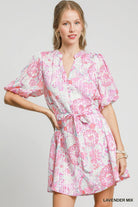 Model wearing a lavender mix floral mini dress with puff sleeves and tie waist