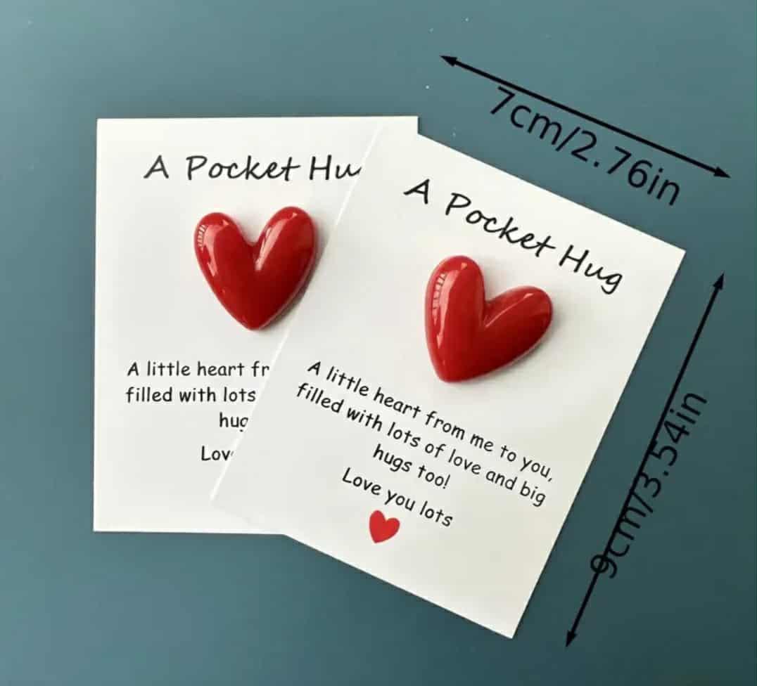 Pocket Hug card with attached red heart token, displayed flat.