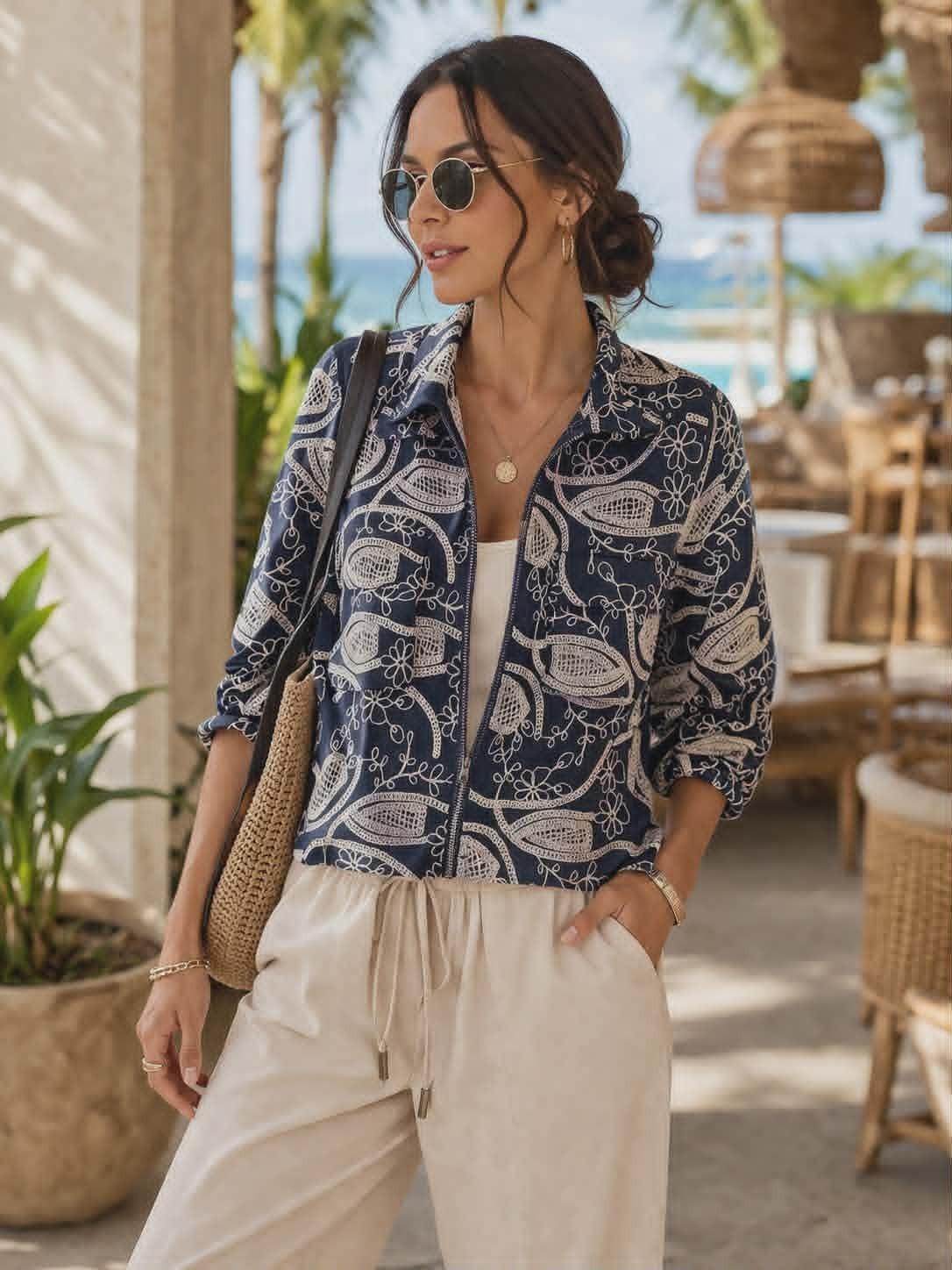 Picadilly navy jacket with beige floral embroidery and zip front detail displayed on hanger in boutique setting