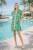 Bold green THML resort print dress with contrast placket and pockets. Lightweight, chic, and perfect for Naples vacation style.