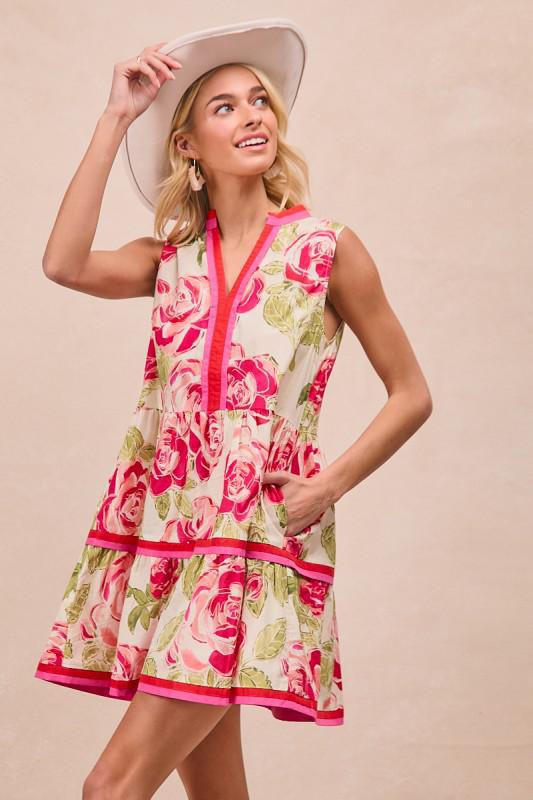 Woman wearing a floral dress and hat on a beige background
