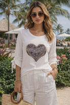 Picadilly white knit top with sparkling sequin heart detail and tie sleeves, chic resort style women’s boutique fashion at Petunias of Naples.