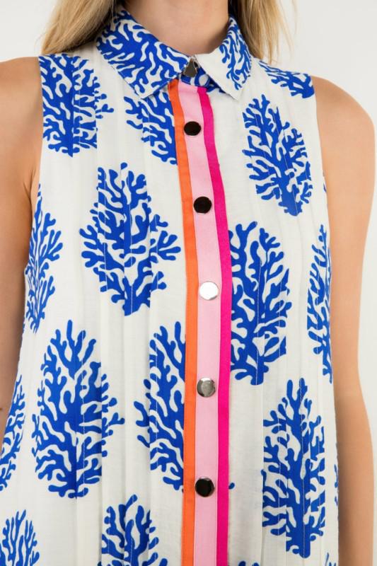 Sleeveless dress with blue coral pattern and colorful buttons, closeup
