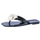Black sandal with white floral design on a white background