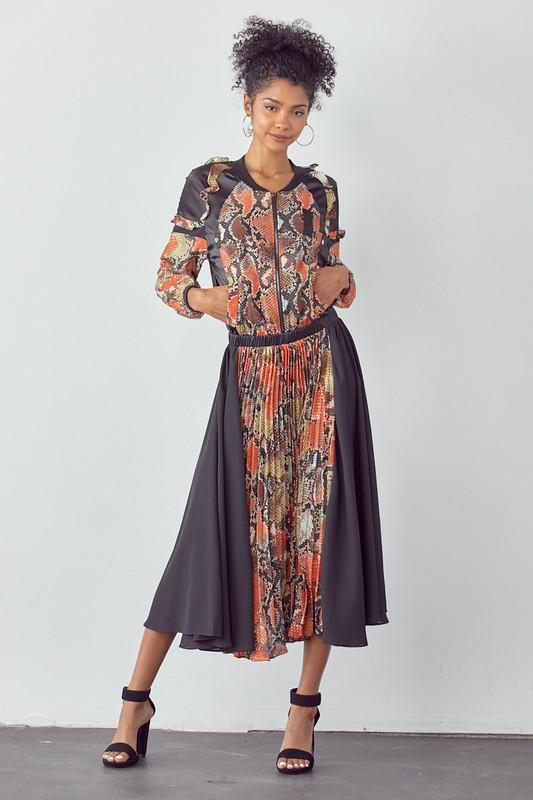 Woman wearing a patterned outfit with a plain background