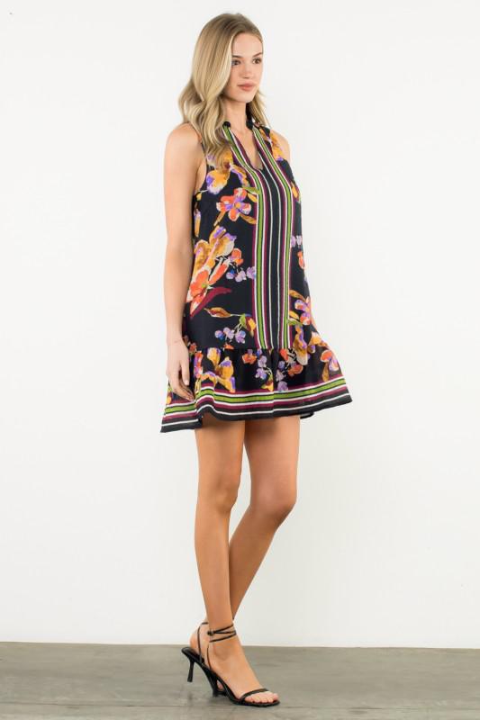 side view of Black sleeveless dress with colorful floral and stripe accents
