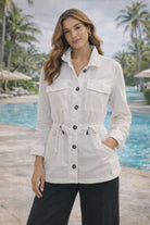White linen blend anorak jacket with button front, drawstring waist, and utility pockets on a resort chic model