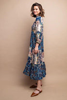 Woman wearing a long, floral-patterned dress against a beige background