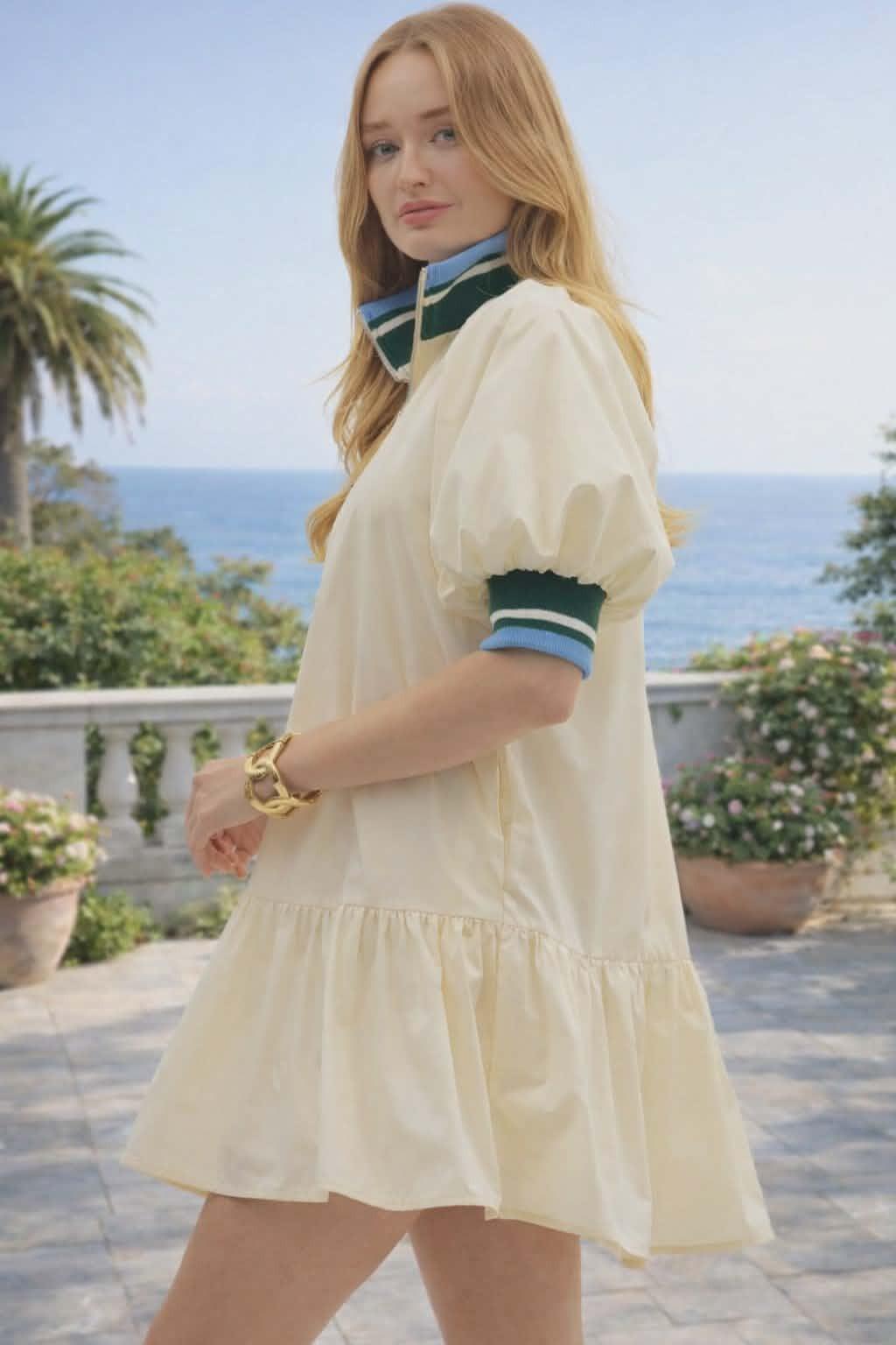 Sporty chic cream half-zip dress with puff sleeves and contrast striped collar