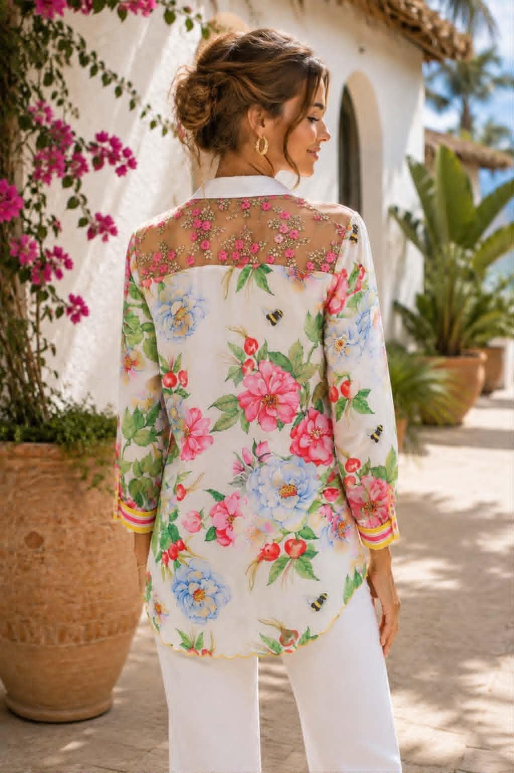 Back of Aratta La Ville Rose blouse featuring a sheer embroidered pink floral yoke, colorful botanical print and striped cuffs.