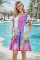 Parsley & Sage watercolor rayon dress with flutter sleeves worn by resort chic model