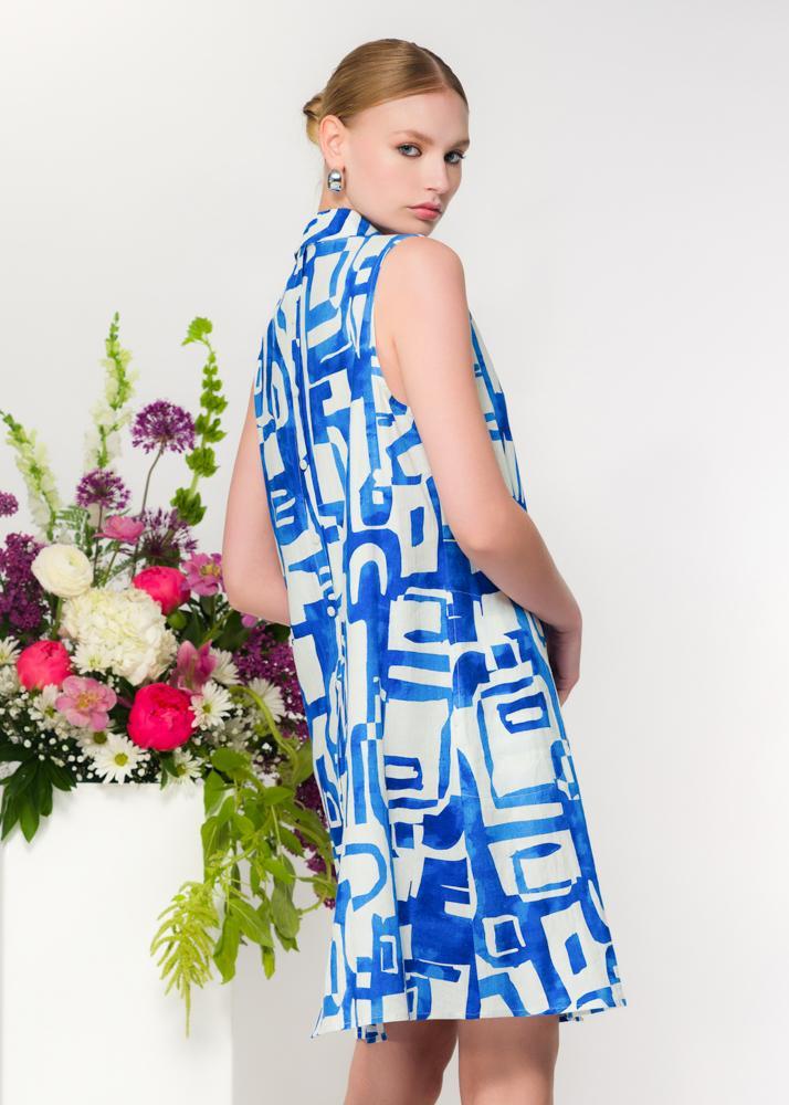 Model wearing Elena Wang blue and white abstract linen blend sleeveless shirt dress with button front, back View