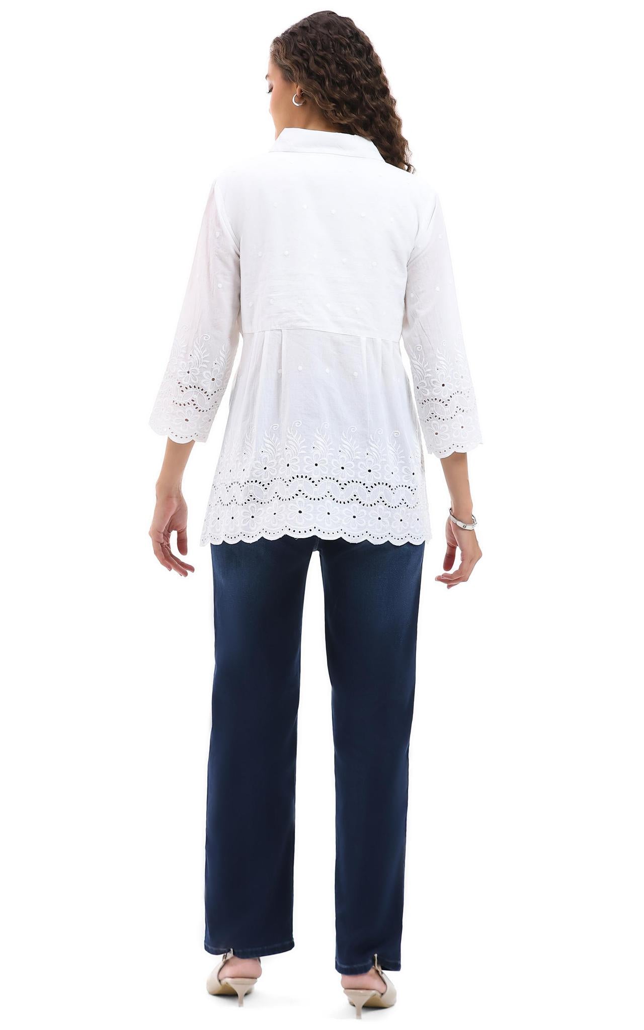 Woman wearing a Parsley  & Sage white lace-trimmed top and navy pants on a white background, back view