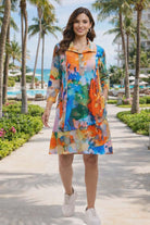Parsley & Sage watercolor abstract print knit dress with collar and pockets shown in resort setting