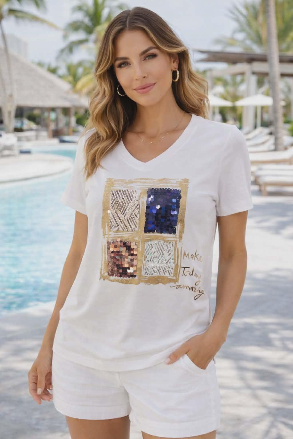 Michael Tyler white V-neck tee with sequin square graphic and “Make Today Amazing” gold script on a resort-chic model
